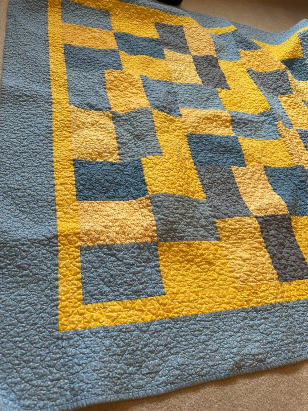 Handmade quilt blanket for baby with blue and yellow patterns. 66" by 100"
